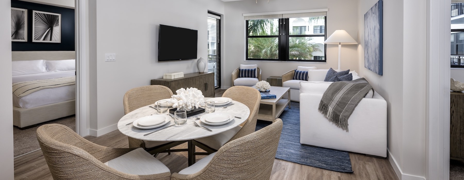 a living room with a couch, dining table and chairs